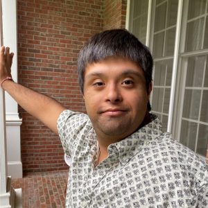 Angad Sahgal leaning against building column, looking at camera
