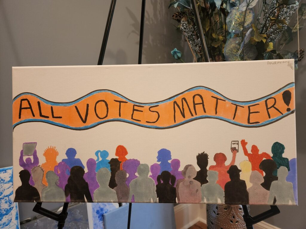 Derek's painting with the text "All Votes matter!" shows a large group of people of different colors and silhouettes in a crowd