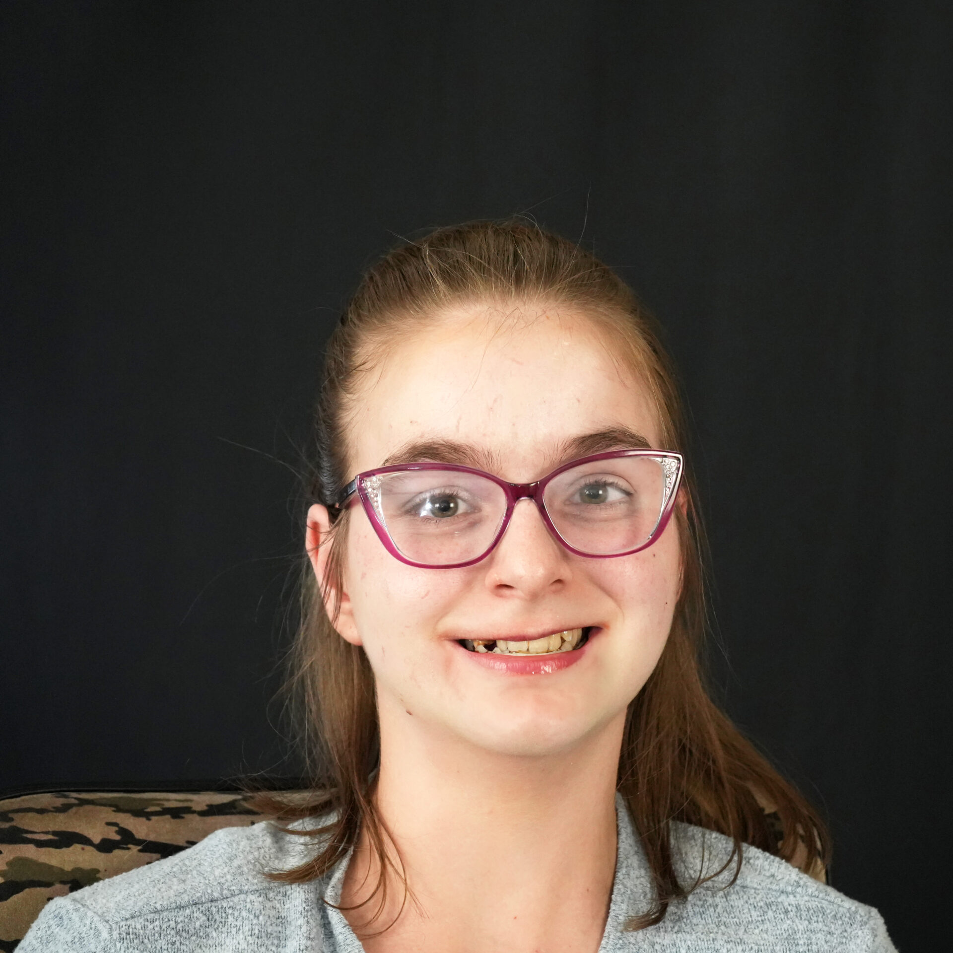 headshot of Jeanie wearing red glasses and smiling